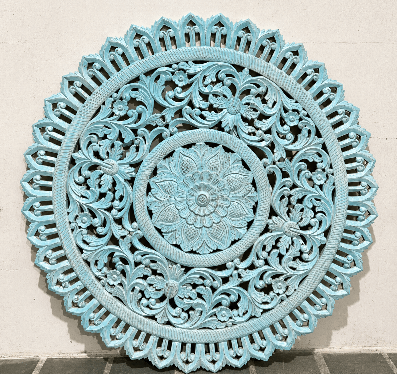 Decorative wall art panel with intricate patterns in a light blue color on a neutral background.