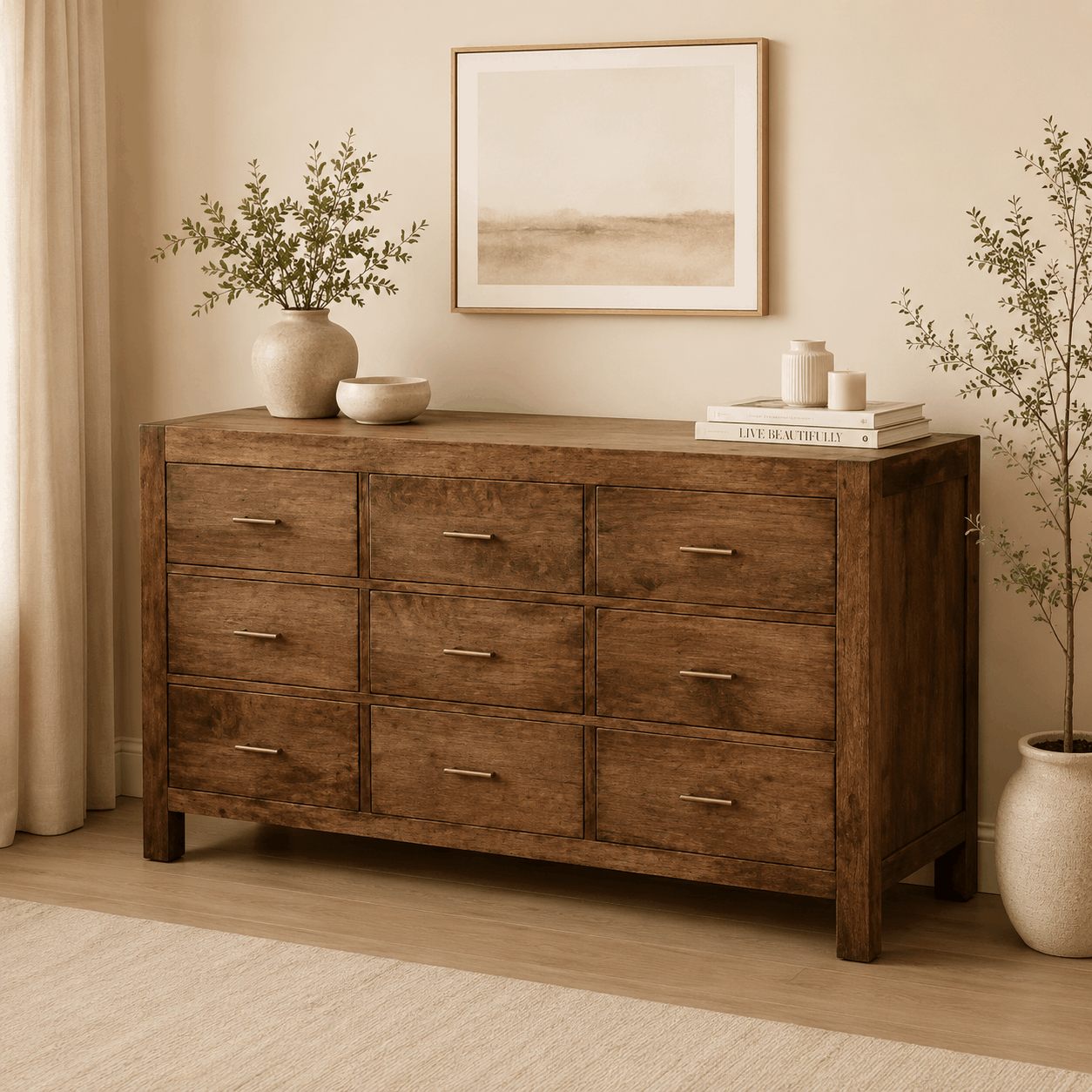 Wooden dresser with decorative items in a room with plants and a painting.