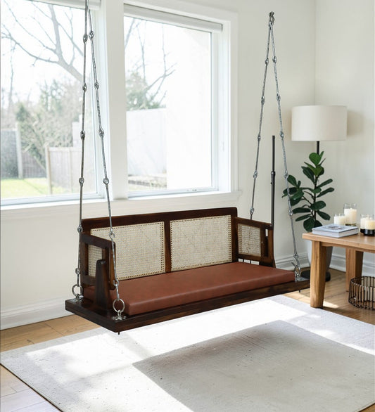 Handcrafted Sheesham Wood Cane Swing with Cushion Seat in a modern sunlit living room - Ferrowoods