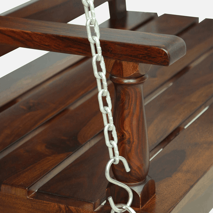 Sheesham wood swing bench with dark finish and metal chains