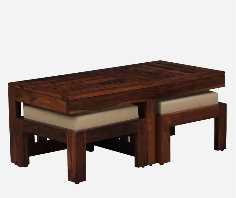 Wooden coffee table with cushioned stools on a white background