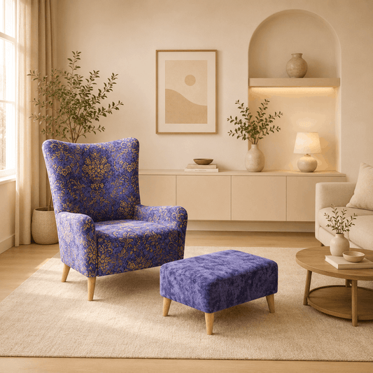 Blue patterned armchair and ottoman in a living room setting with decor elements.