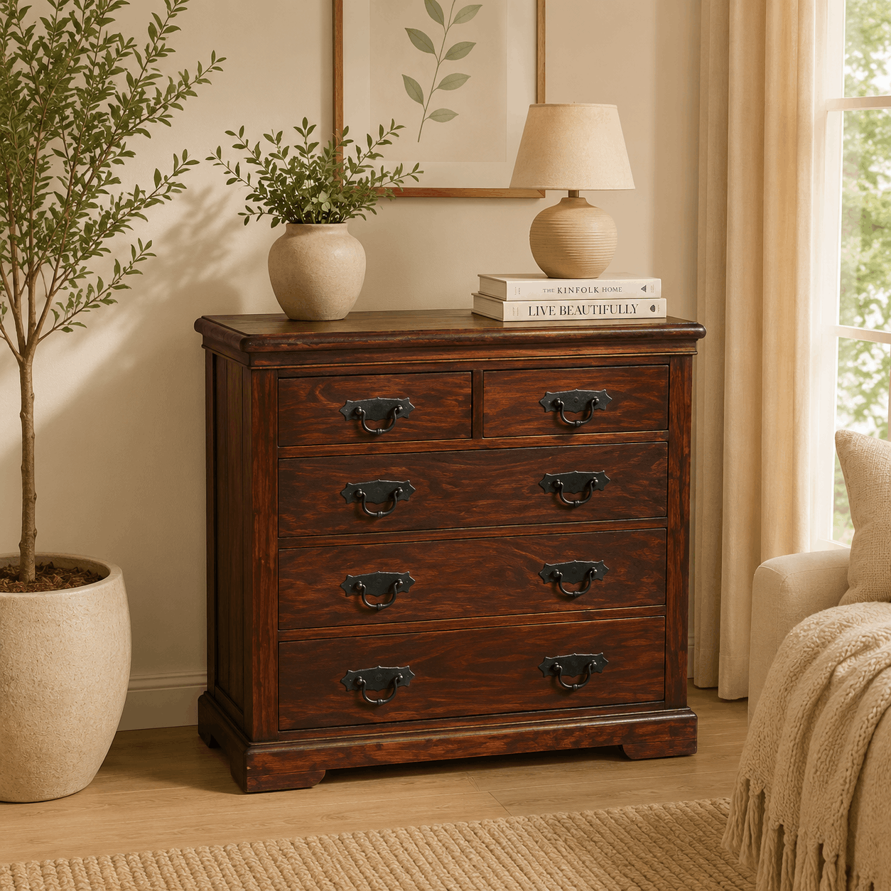 Wooden dresser with decorative items in a room with a plant and lamp.