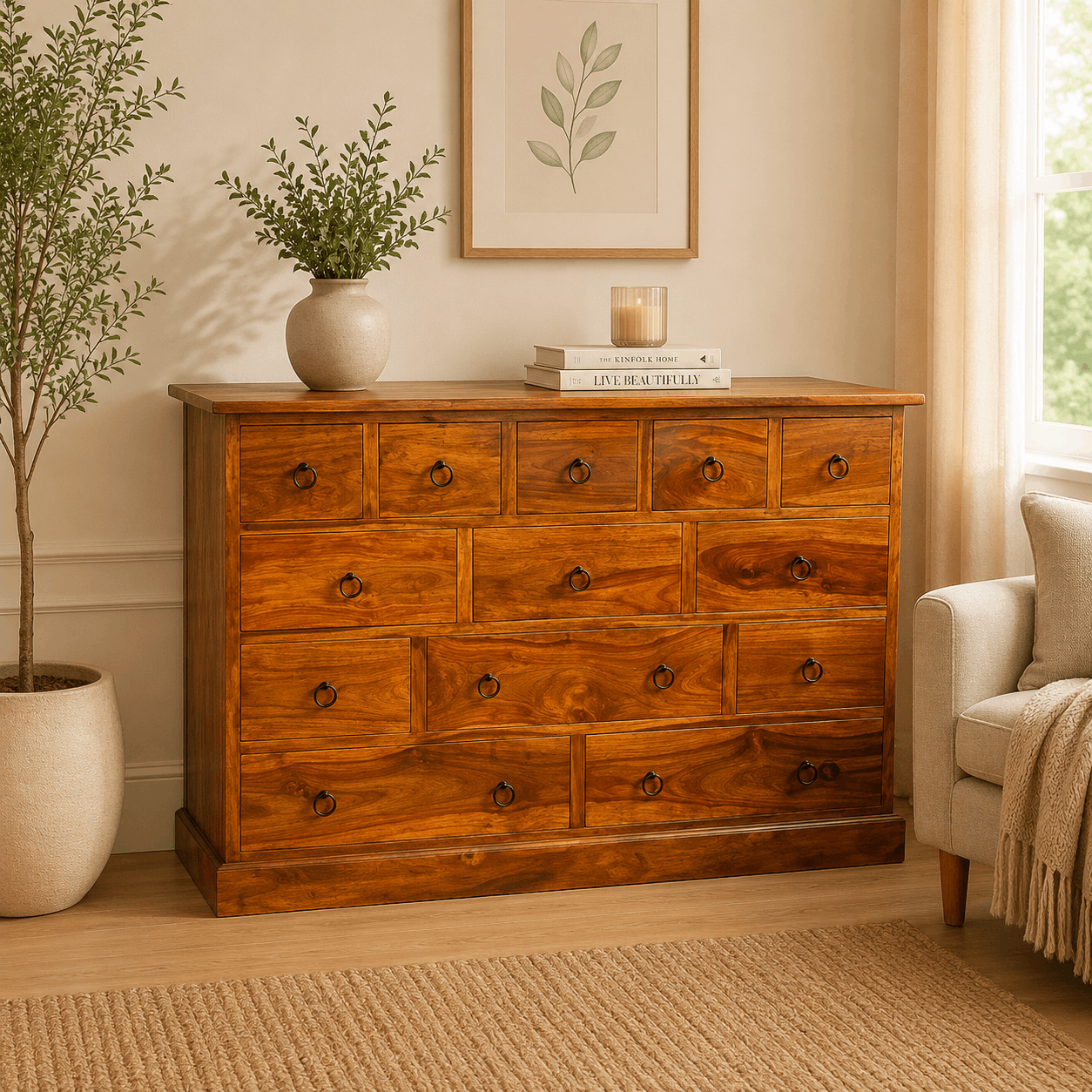 Wooden dresser in a room with a plant, books, and a candle