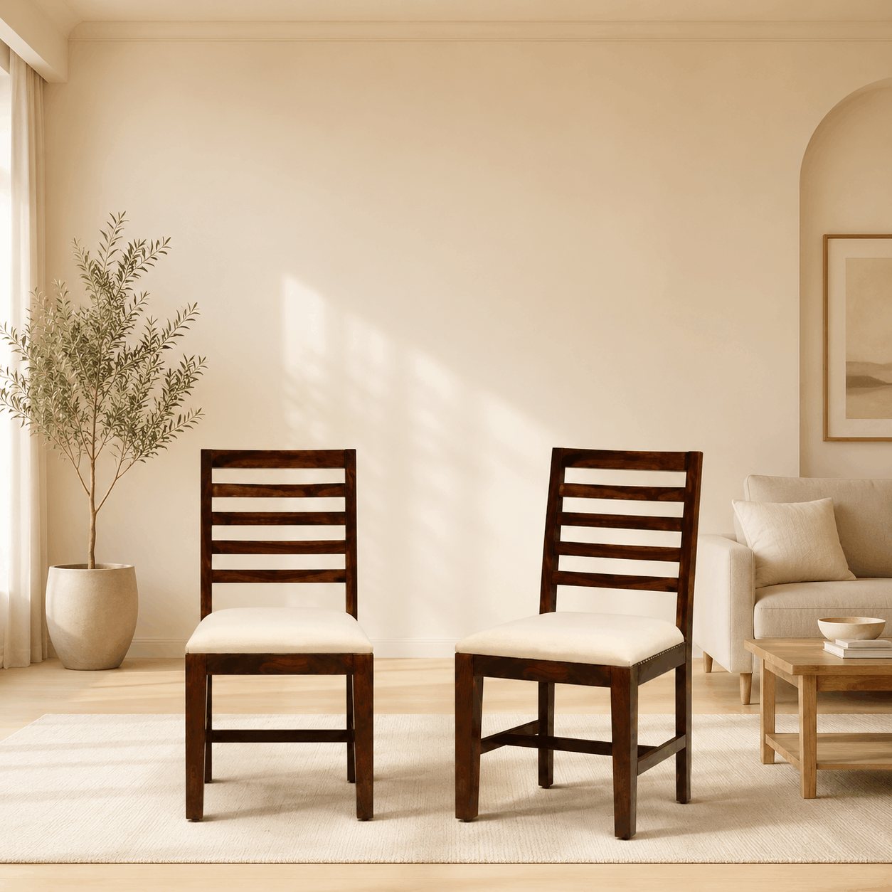 Two wooden chairs with white cushions in a living room setting.