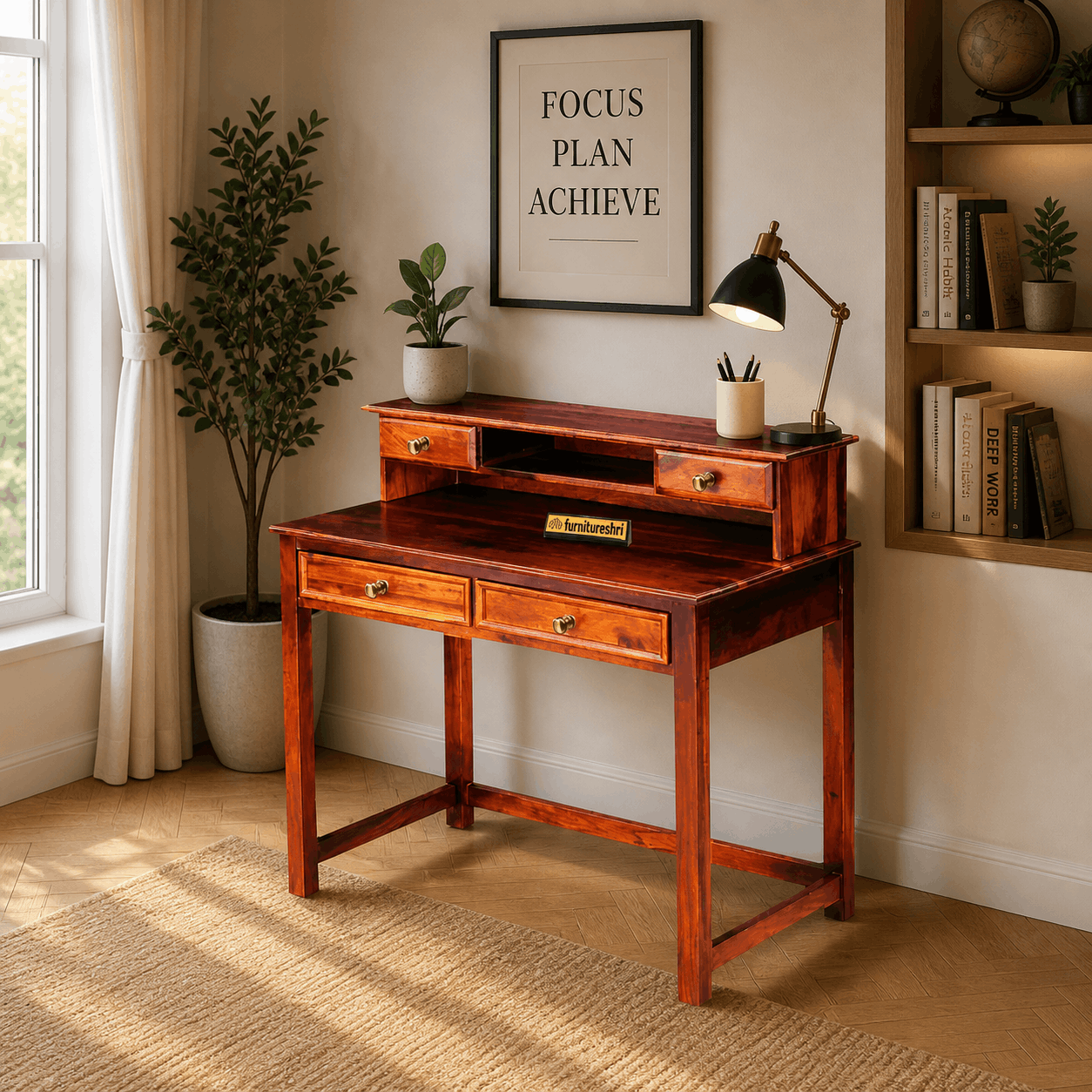 Wooden desk in a room with a framed poster, lamp, and plants.