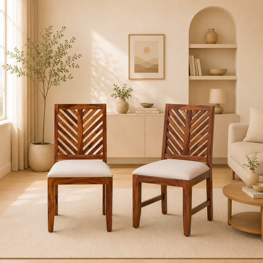 Two wooden chairs with white cushions in a bright living room.