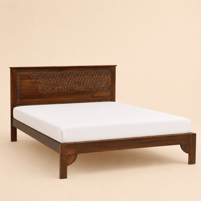 Wooden bed with intricate carvings on a beige background