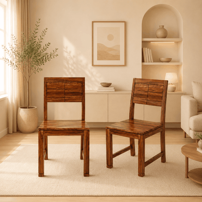 Two wooden chairs in a living room with a neutral color palette.