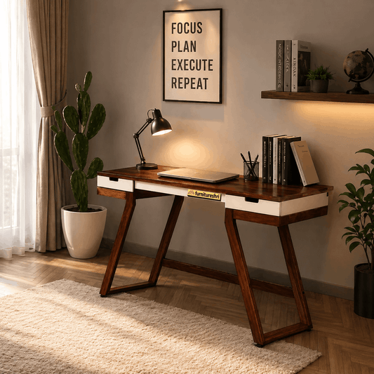 Wooden desk in a home office with plants, books, and a motivational poster.