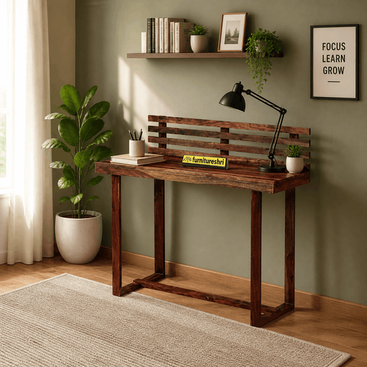 Wooden desk with lamp and decor items in a room with green walls and a plant.
