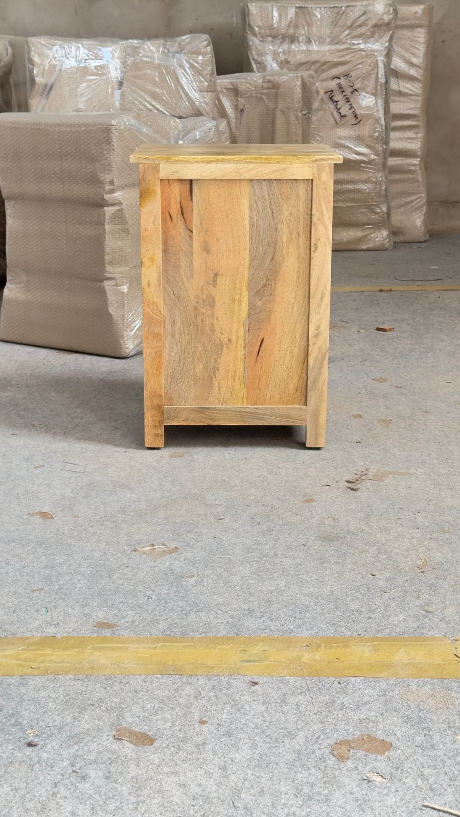 Solid wood side table with natural finish and panel door design