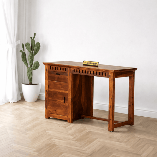 Wooden desk in a room with a plant and a decorative item on the surface