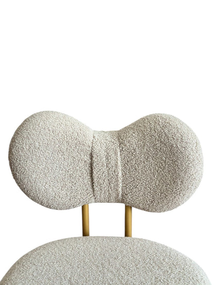 Decorative chair with textured backrest and seat on a white background