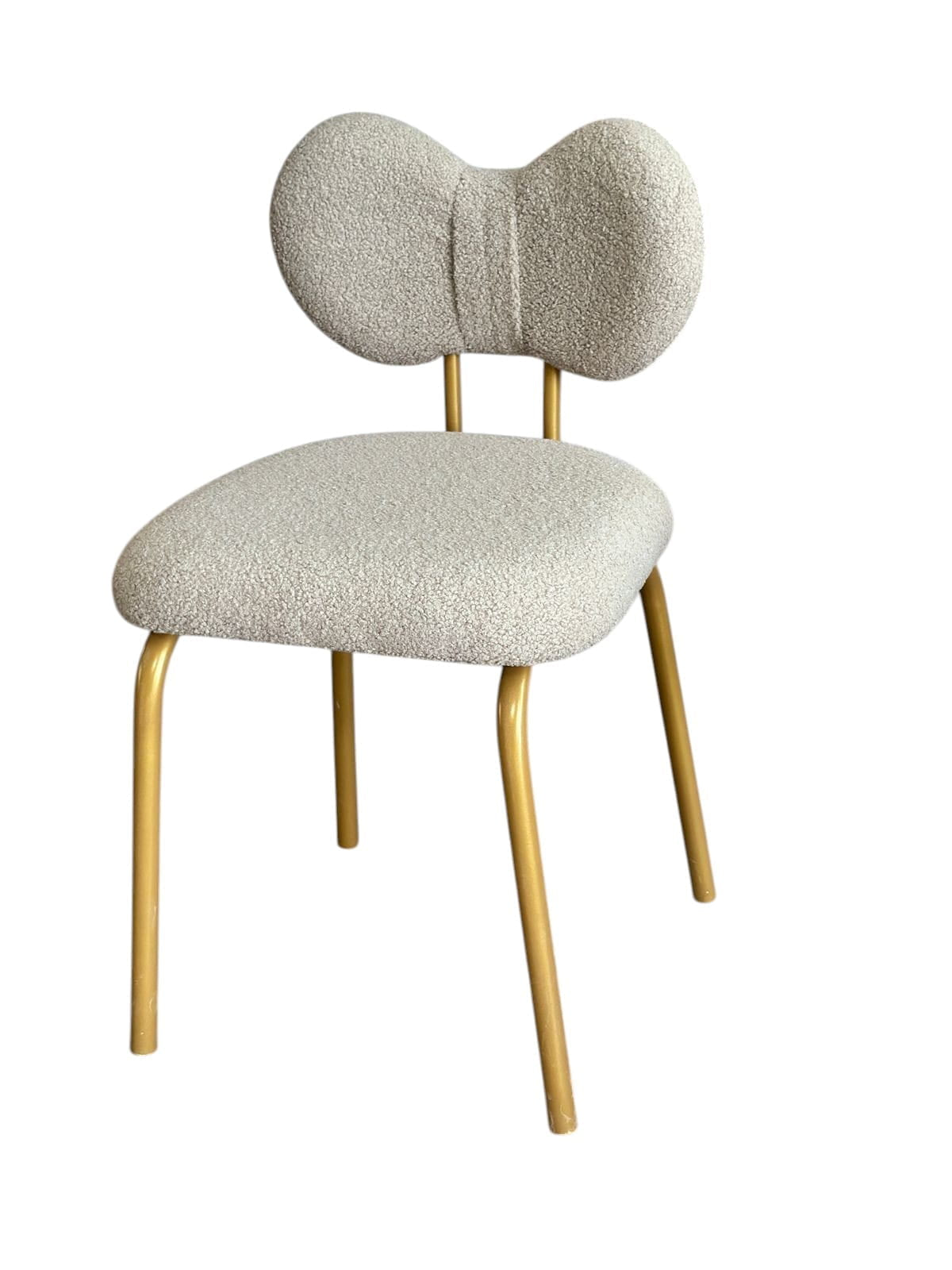 Chair with beige upholstered seat and backrest and gold metal legs on a white background