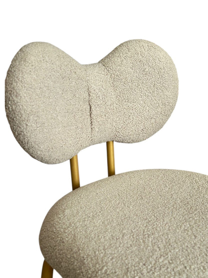 Chair with textured beige backrest and seat on a white background