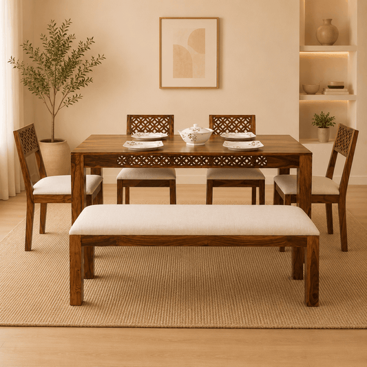 Dining room with wooden table, chairs, and bench in a warm-toned room.