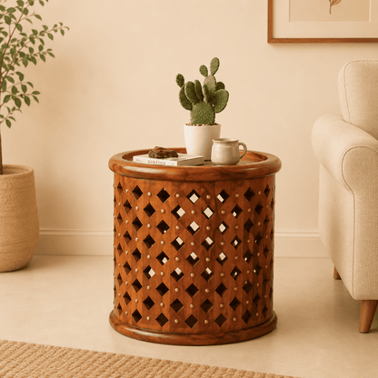 Wooden side table with a cactus plant and a mug in a living room setting.