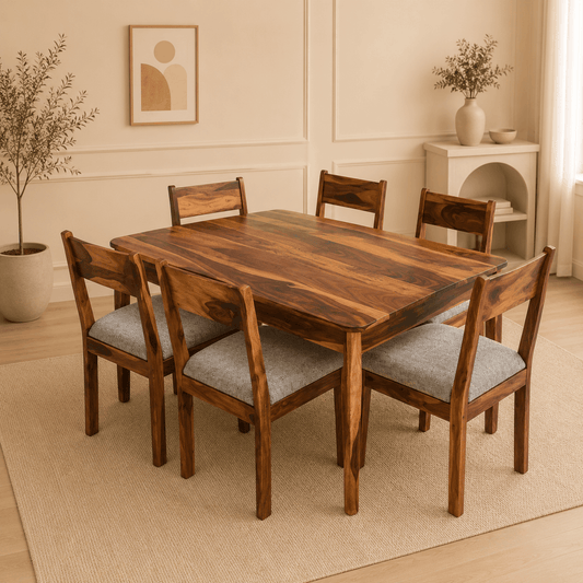 Wooden dining table with chairs in a room with a plant and shelf.