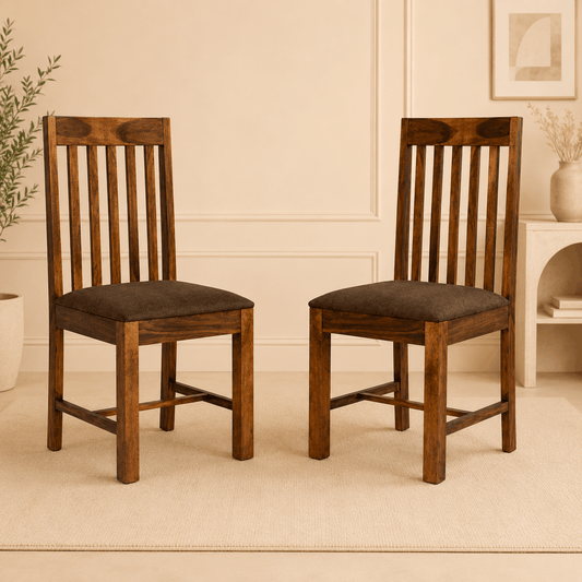 Two wooden chairs with brown cushions on a beige carpeted floor.