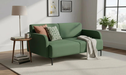 Green sofa with decorative pillows in a living room setting