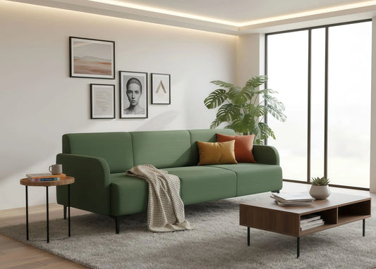 Modern living room with a green sofa, coffee table, and decorative elements.