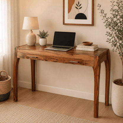 Wooden desk with laptop, books, and decor in a home office setting