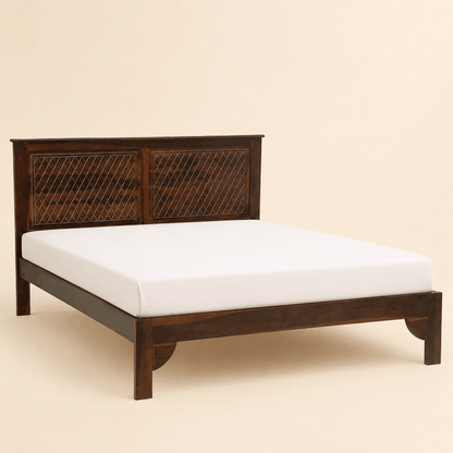 Wooden bed frame with white mattress on a beige background