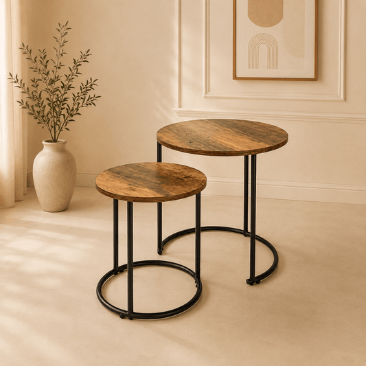 Two wooden side tables with black metal legs in a room with a vase and plant.