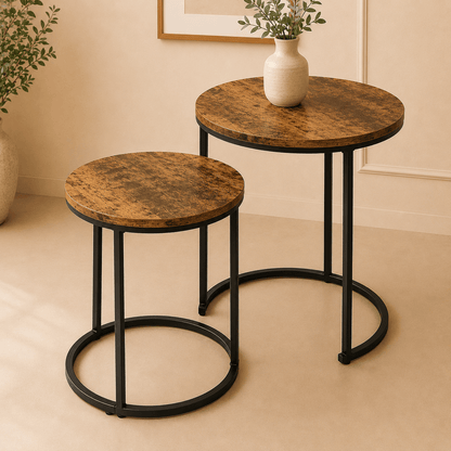 Two round side tables with marble-like tops and black metal legs on a beige floor.