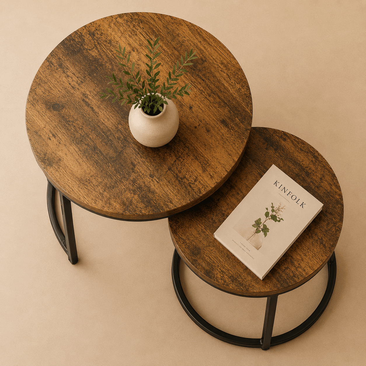 Two wooden side tables with a plant and a book on a beige background