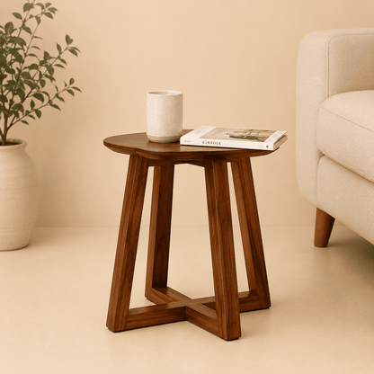 Wooden side table with a cup and book in a living room setting