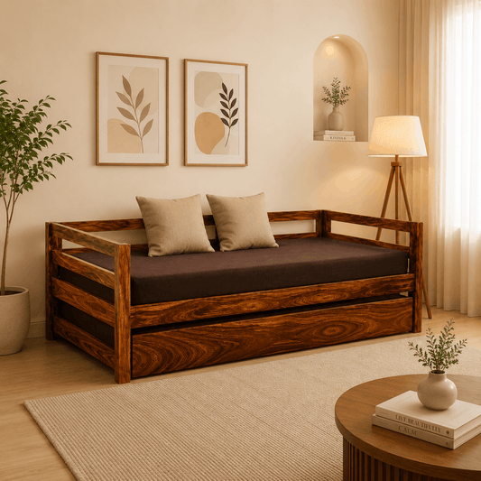 Wooden sofa bed in a room with decor elements like a lamp, plant, and wall art.