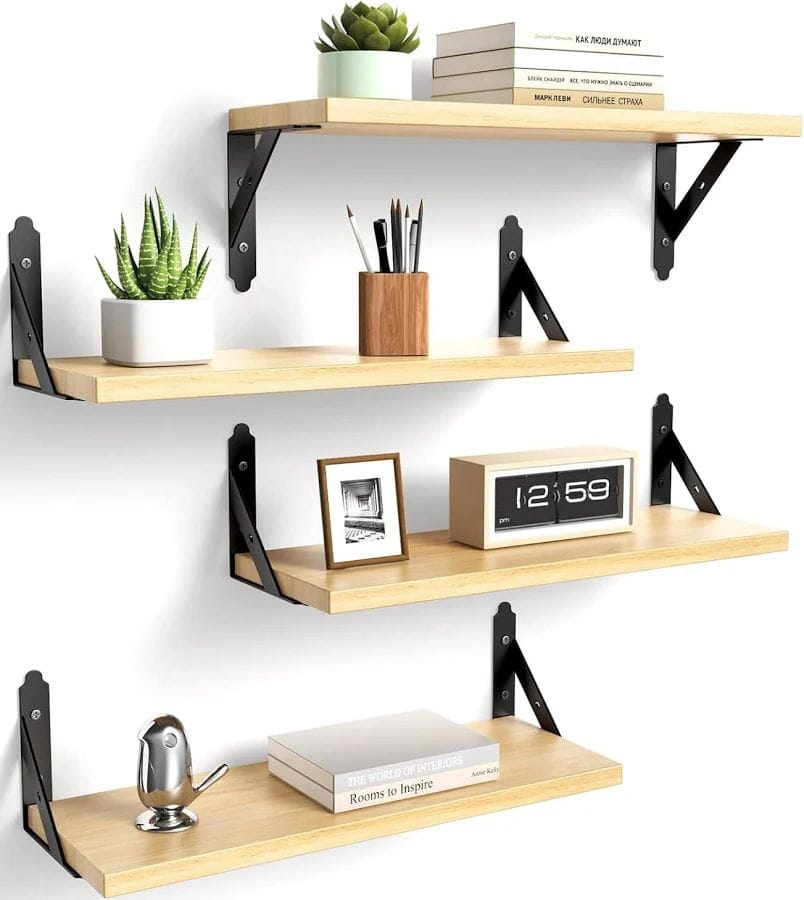 Wooden wall shelves with various decorative items on a white background