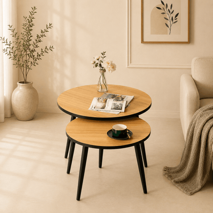 Round wooden coffee table with a magazine and cup in a living room setting.