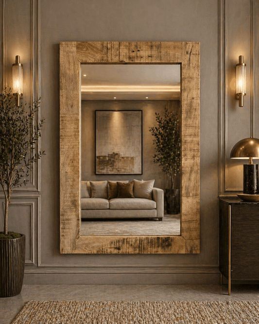 Large wooden-framed mirror in a room with a sofa and decorative elements.